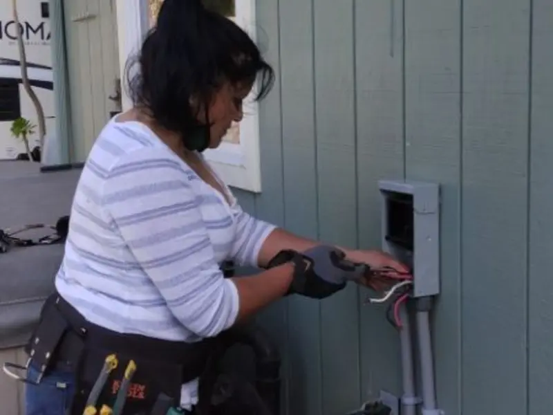 Licensed electrician wiring an exterior subpanel in Americus