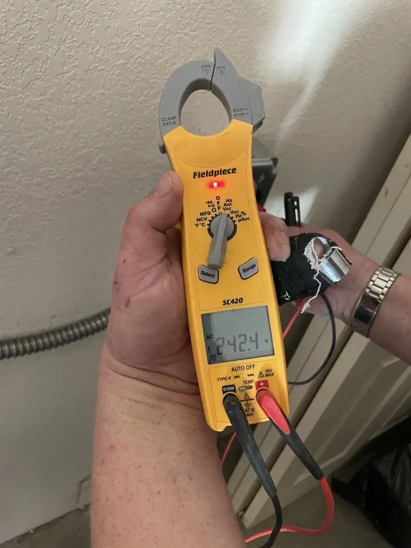 Voltage testing with clamp meter during Recessed Lighting Installation in Americus